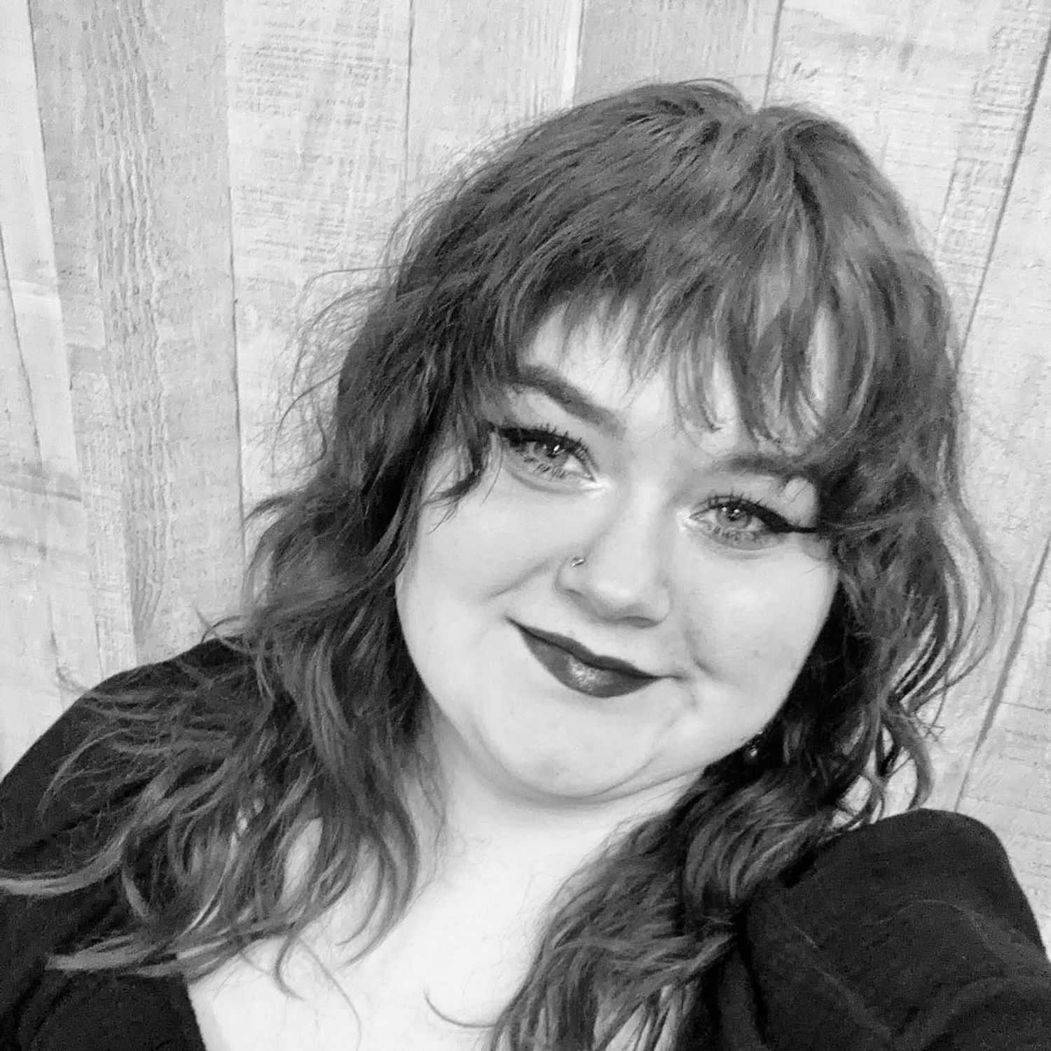 Portrait of Millie, a professional stylist at Good Vibes Salon, showcasing their expertise and style.